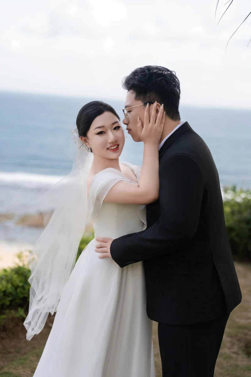 海边新娘微笑依偎在新郎身旁